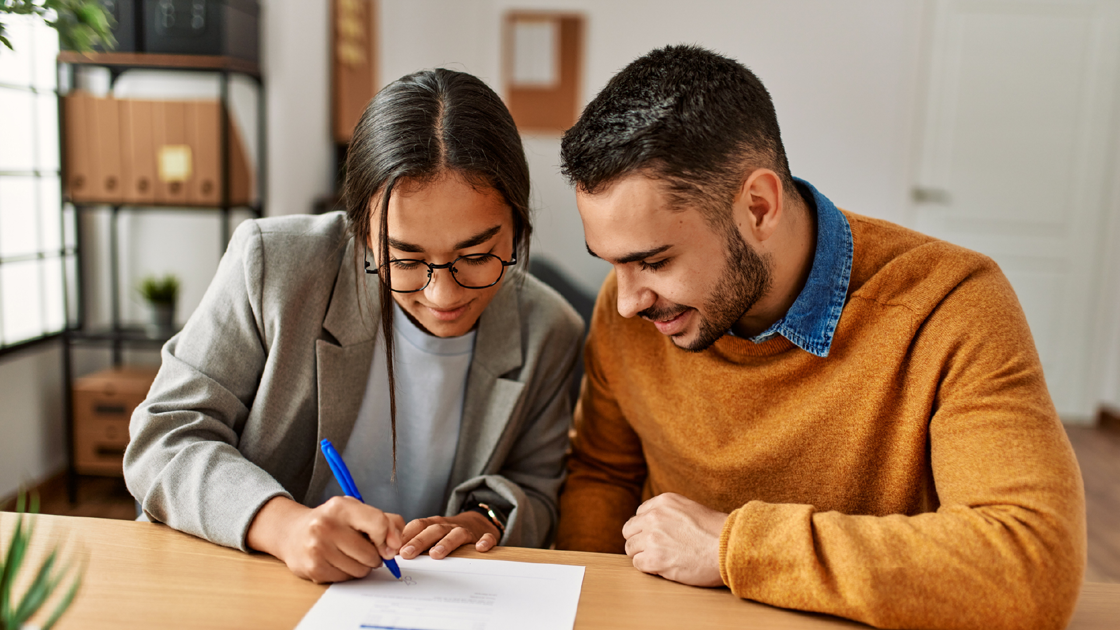 decorative image of a couple signing a document
