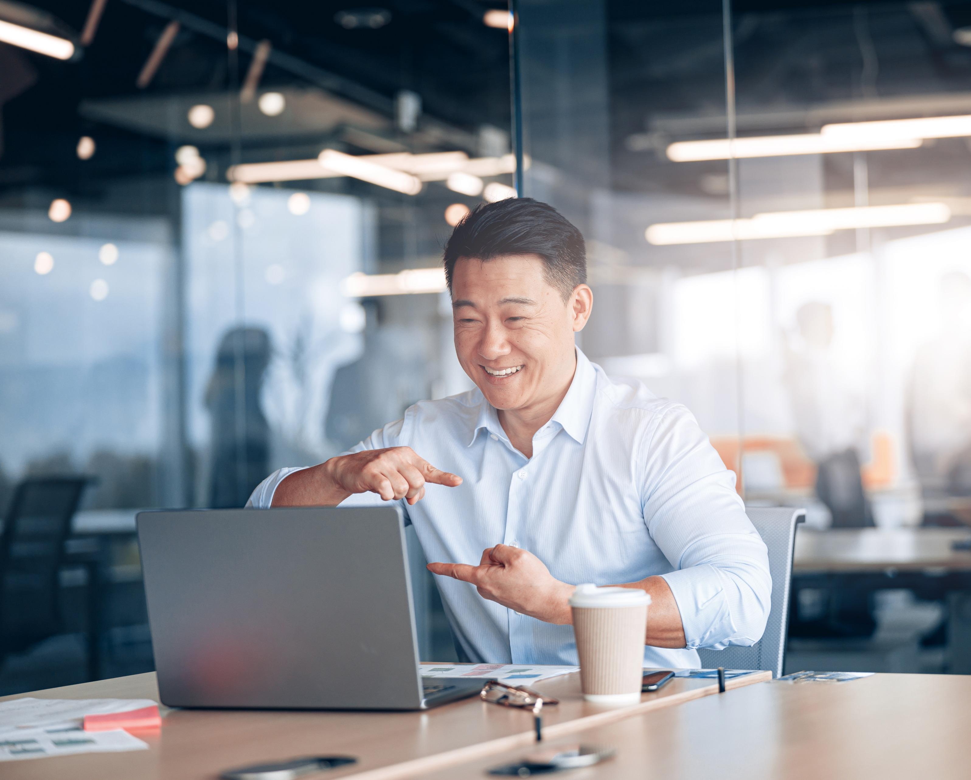 Image of man on laptop using sign language to communicate by video call